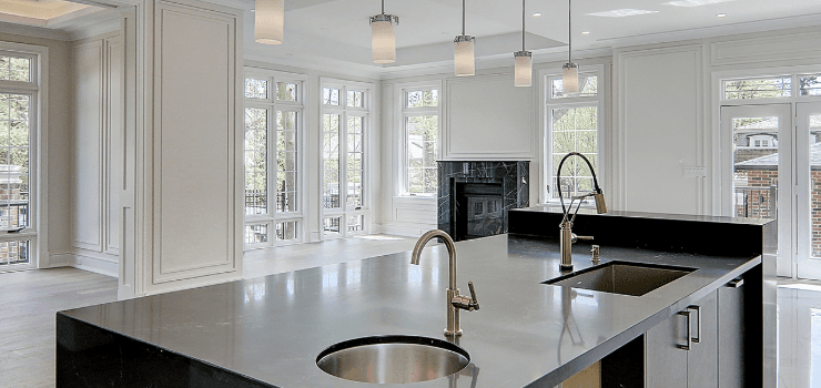 A modern kitchen with an island and two sinks.